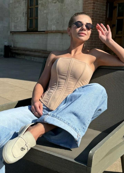 Girl in nude or beige corset