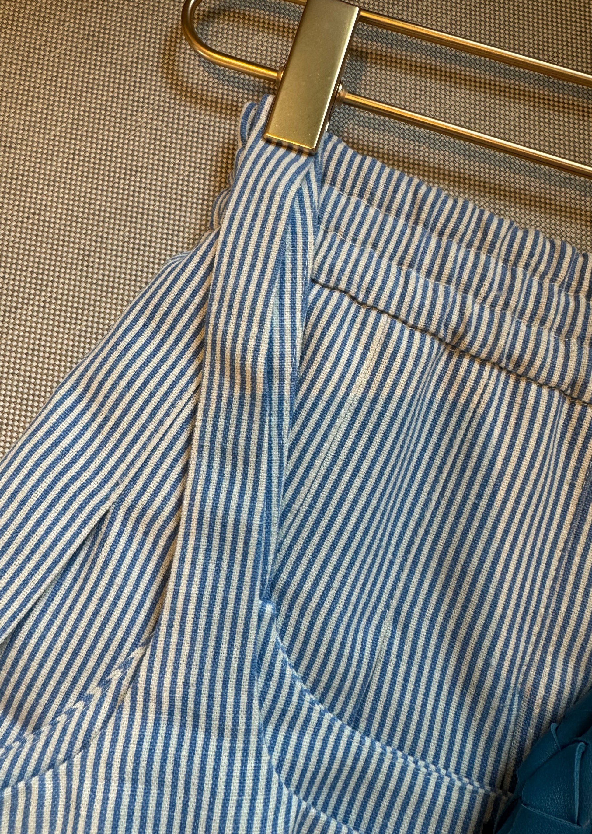 Details of the blue suit, top and skirt