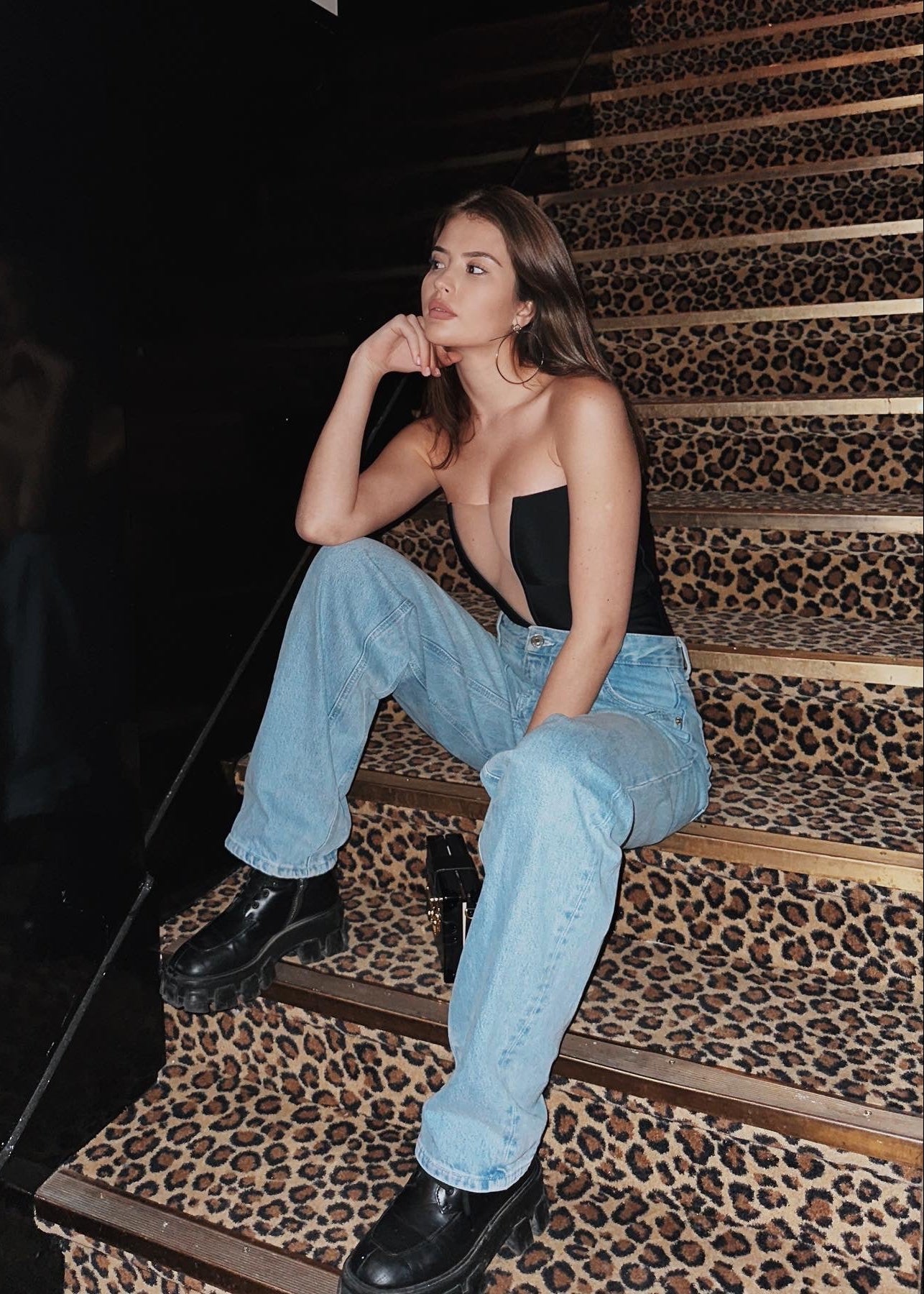 Woman sitting on a staircase with leopard print steps