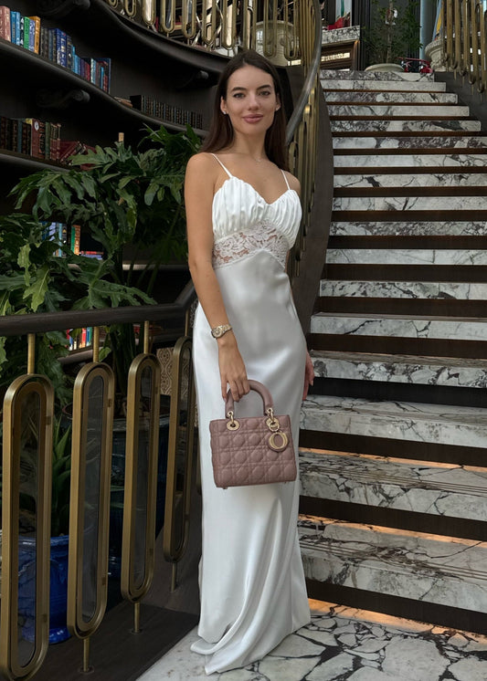 Girl in long white satin dress with lace