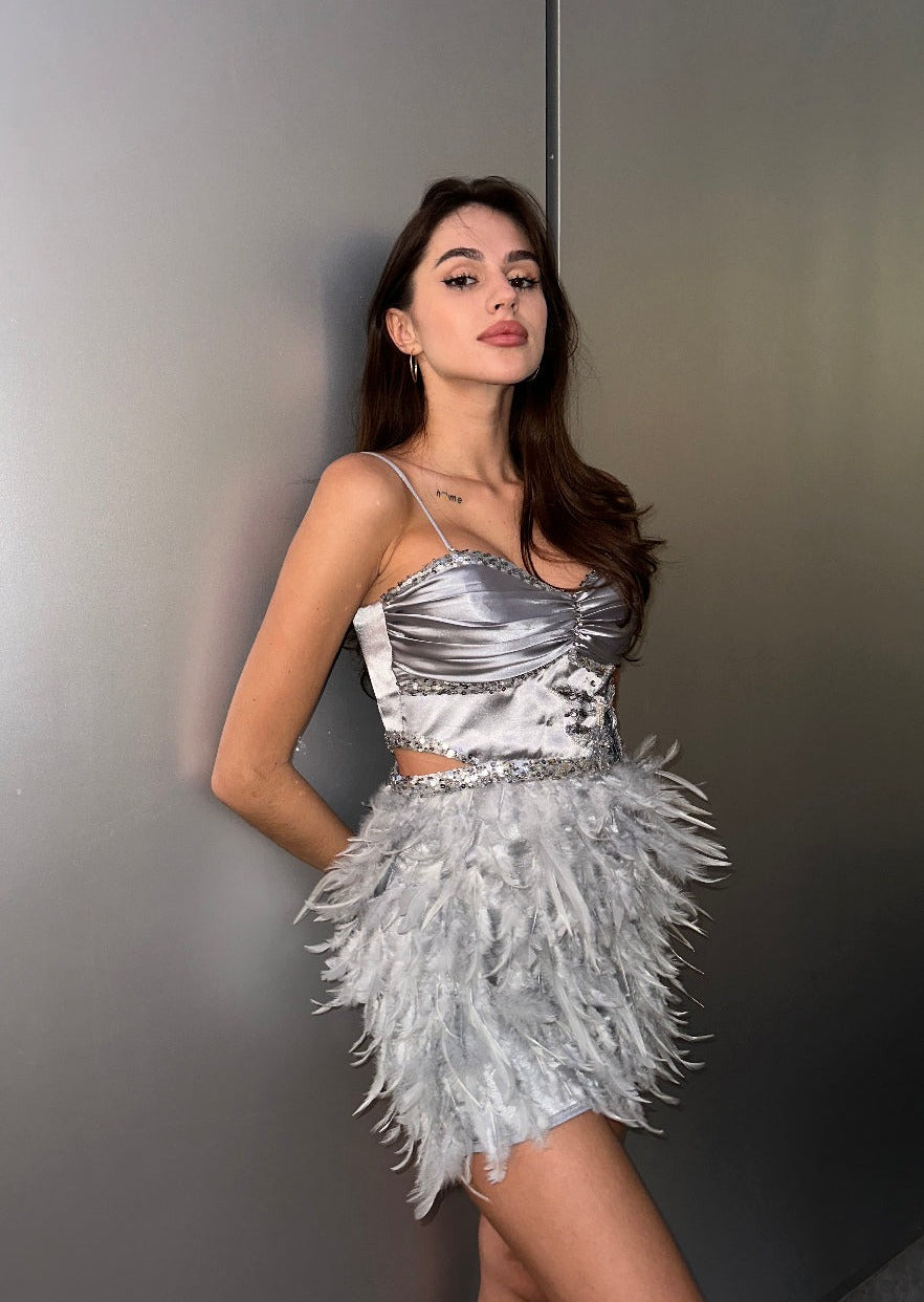 Girl in grey dress with feathers