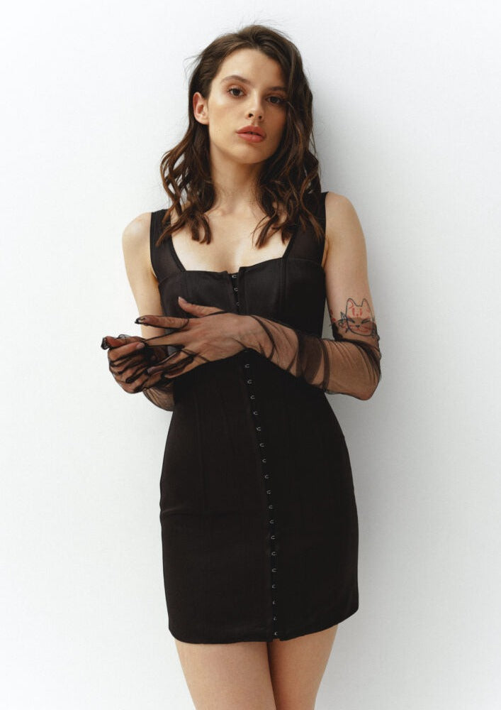 Girl in corset black mini dress with hooks