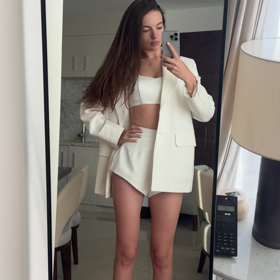 Girl in white suit shorts with jacket