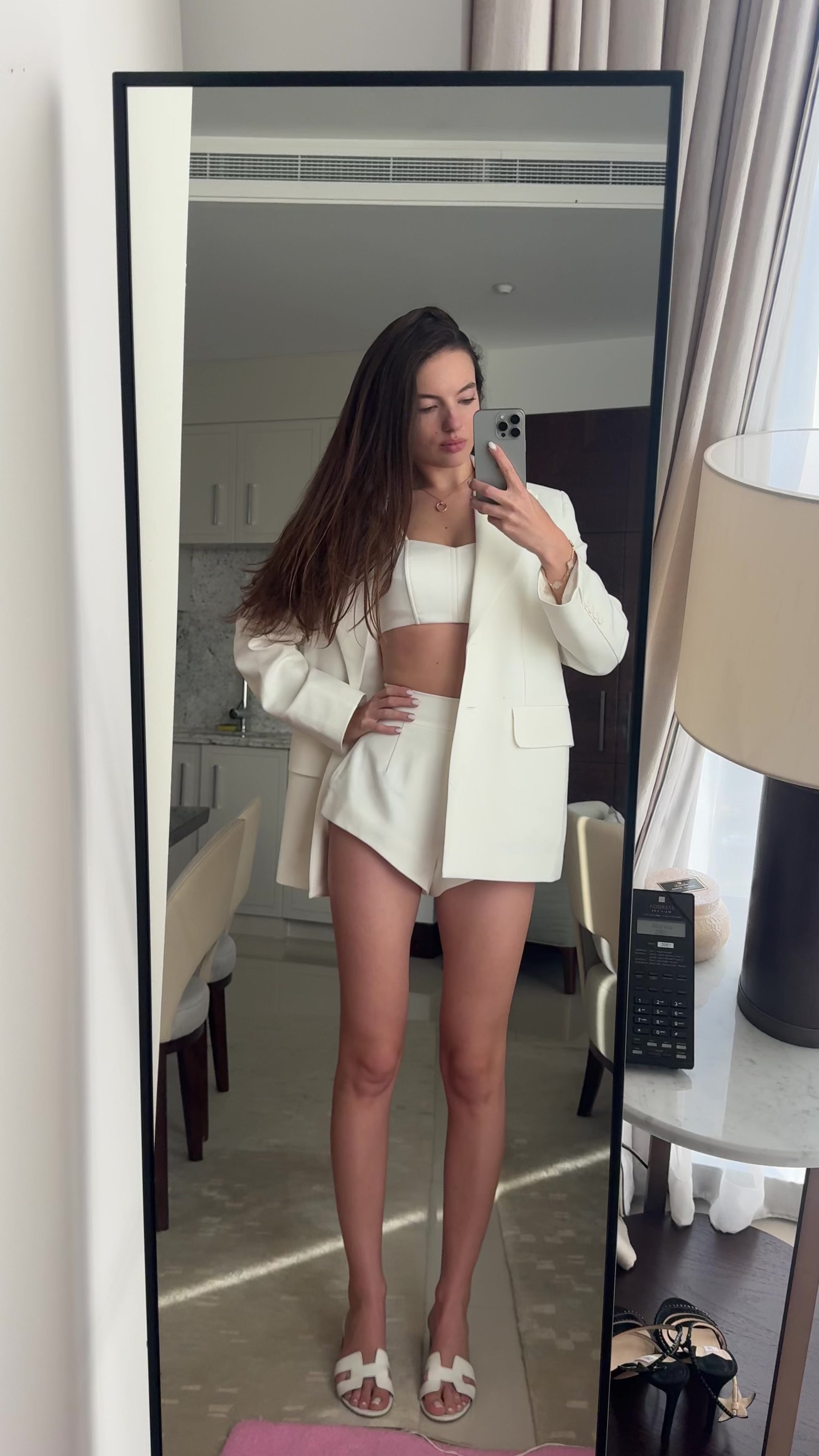 Girl in white suit shorts with jacket