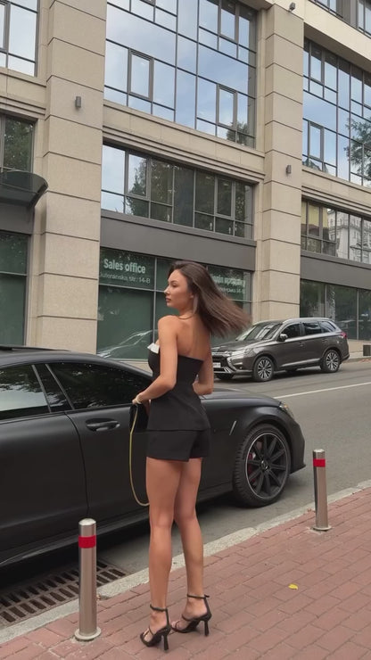 Girl in black suit top with shorts